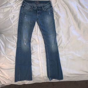 Semi distressed mid rise boot cut jeans